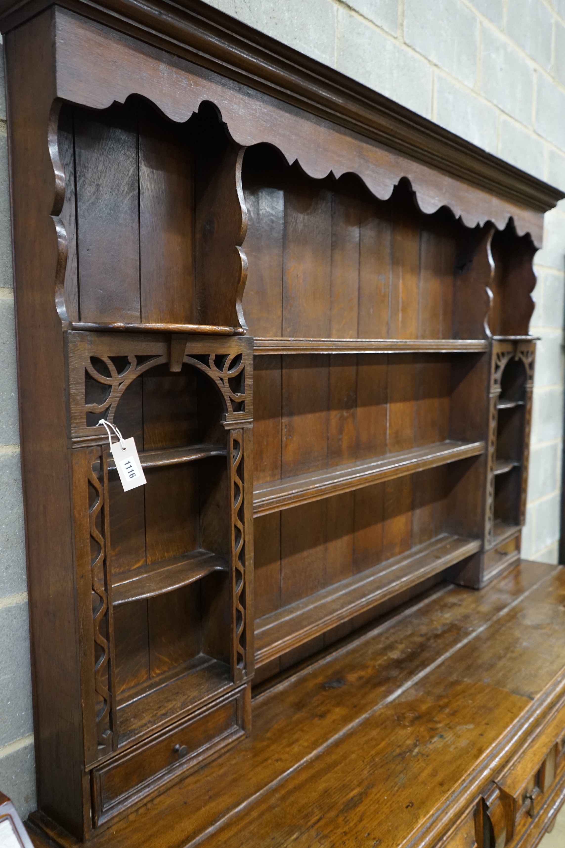 An 18th century style oak dresser with boarded rack, width 178cm, depth 51cm, height 200cm